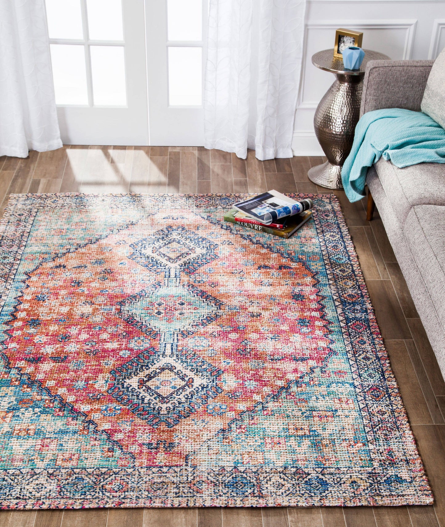 a living room with a couch and a rug on the floor